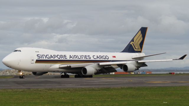 Boeing 747-400 (9V-SFM) - Turning off 05R one evening.