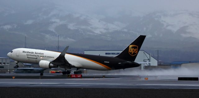 BOEING 767-300 (N360UP) - Early morning departure from Runway 16R as dawn light breaking at Reno Tahoe International reveals a steady drizzling rain.