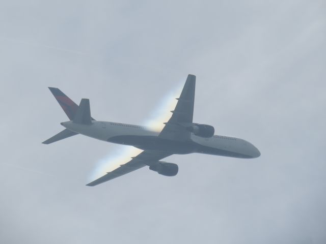 Boeing 757-200 (N654DL) - Humid air at beach provides an effect as the jet passes through.