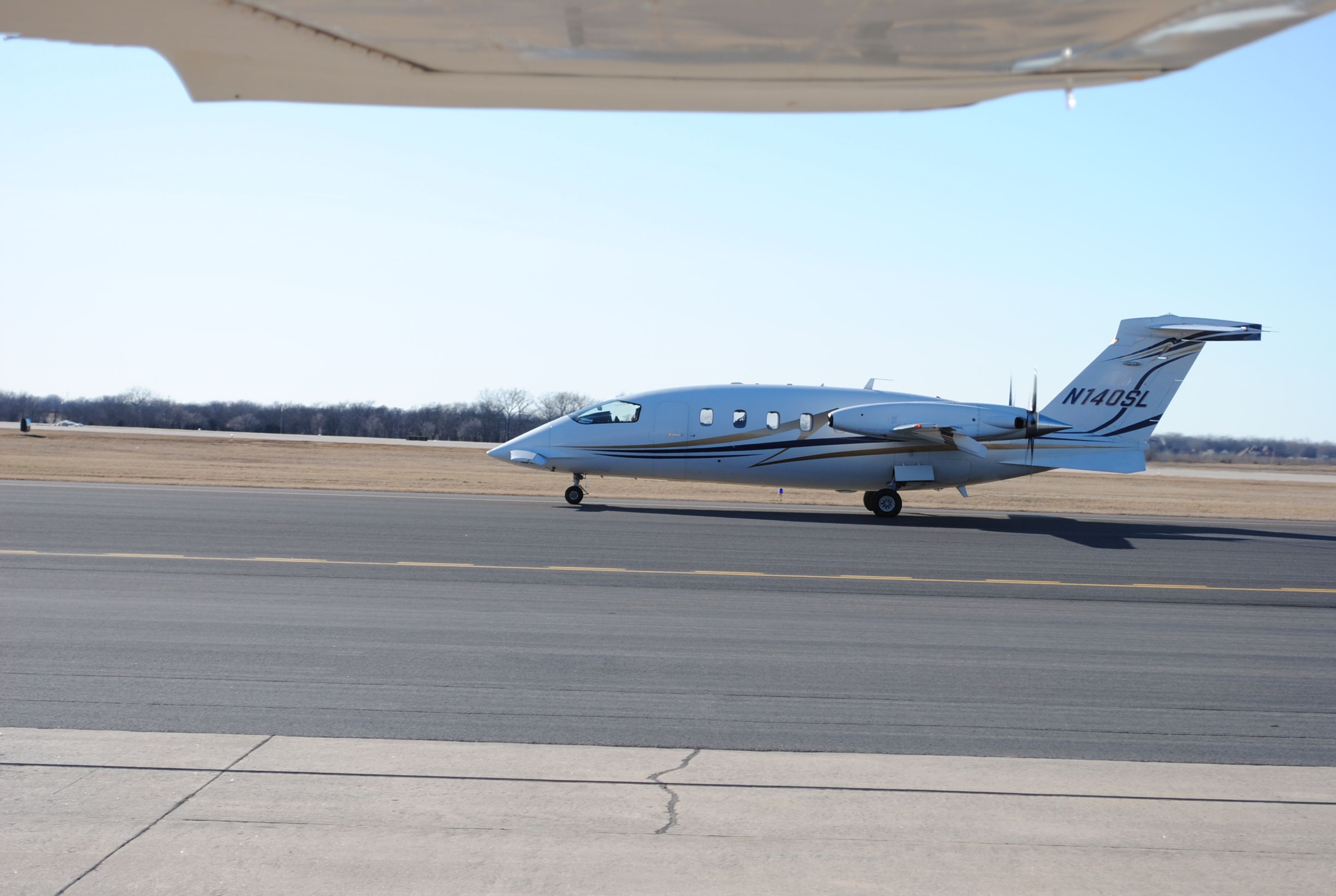 Piaggio P.180 Avanti (N140SL) - I took this while doing my preflight. This is a Piaggio taxiing from the Atlantic FBO on taxiway A for a departure on runway 35R.