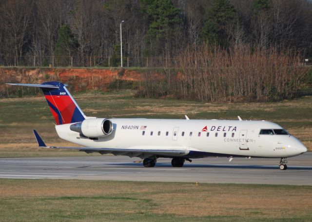 Canadair Regional Jet CRJ-200 (N8409N) - Lined up and waiting 18C - 3/18/11