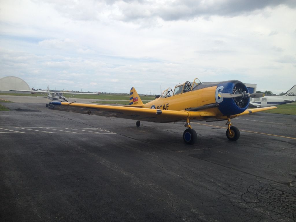 North American T-6 Texan (C-FSIX) - Harvard returning from Oshkosh. Taken on the Great Lakes Flight Centre ramp, Windsor, Ontario.