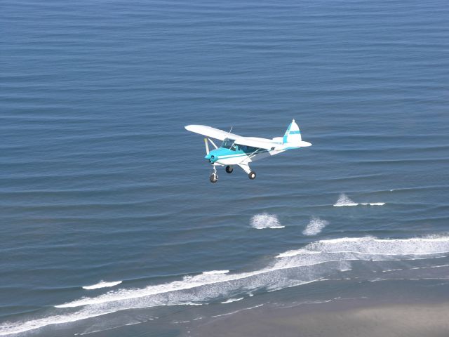 Piper PA-22 Tri-Pacer (N6931D) - Photo over the Pacific Ocean shoreline.