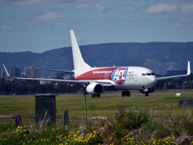 Boeing 737-800 (VH-VUY) - On taxi-way heading for a long take off run on runway 05. Carrying the special Australian Football League livery reflecting Virgin Blues role as the official air carrier for the A.F.L.