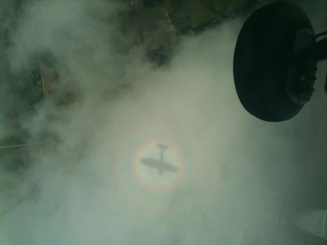 Cessna Commuter (N61205) - Photo taken above a scattered layer of clouds in East Central Iowa, close to Berlington, at about 5,500 feet.  It is looking down from inside a Cessna 150 onto the shadow of the 150 on the clouds. The rainbow is no trick, but natural.  How often do we remember to look for this wondrous beauty as pilots/riders?