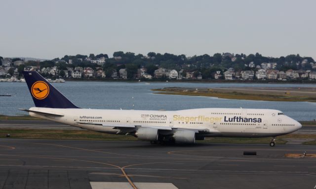 BOEING 747-8 (D-ABYK) - Lufthansa B747-830 (D-ABYK) in special Siegerflieger – Olympia 2016 livery departing BOS for FRA. This plane was used to carry the German Olympic team during the Olympics.