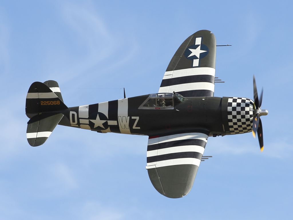 — — - A Republic P-47 Thunderbolt performs a high speed flypast at Duxford.