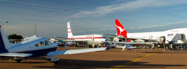Piper Cherokee (VH-URK) - Visiting Longreach. Also visible are aircraft of the Qantas Museum; 707, 747, DC-3