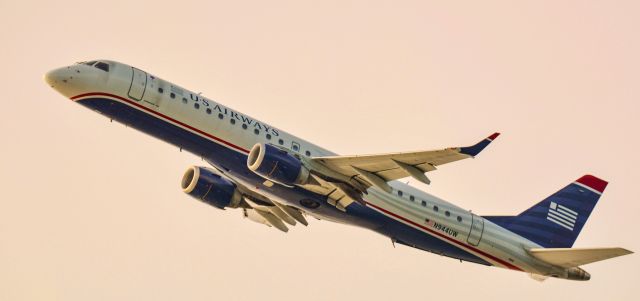 Embraer ERJ-190 (N944UW) - E190 with fast disappearing US Airways livery over Boston South End. 