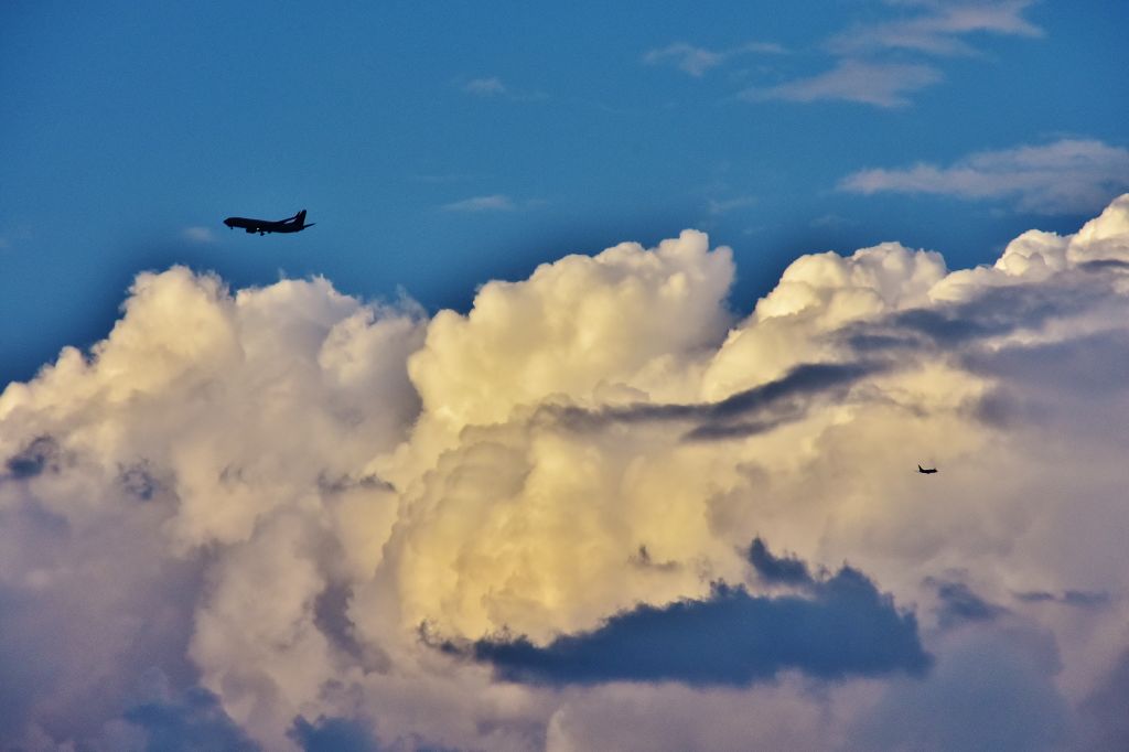 Boeing 737-700 (UNKNOWN) - Southwest Airlines 737-800 approaches McCarran International Airport in Las Vegas Nevada as another aircraft departsbr /Thunderheads boil up in the late afternoon over the Mojave desert