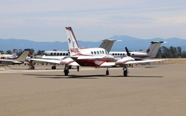 Cessna 421 (N401DL) - KRDD -br /the only vantage point I could get on these 3 twins. The 421 is Blue Star Gas out of Central Pt. Oregon basking in the 99 degree Redding weather, though I imagine it is over 100 on the tarmac. The US Marine Corp twin was a surprise to see, unable to get any a/c data during the .5 hr lunch run...6/22/2018.