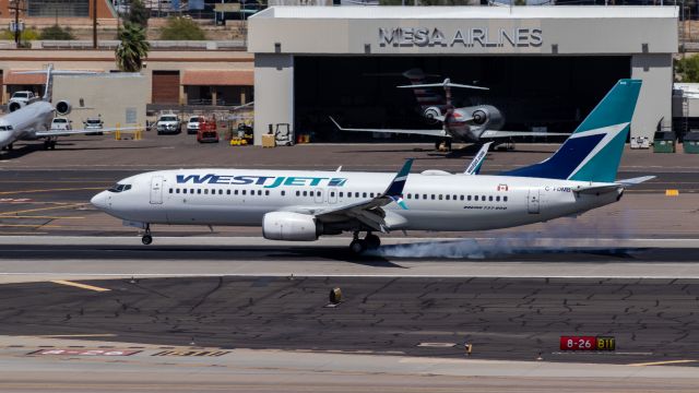 Boeing 737-800 (C-FDMB) - WestJet 737-800 landing at PHX on 4/12/22. Taken with a Canon 850D and Canon 75-300mm lens.