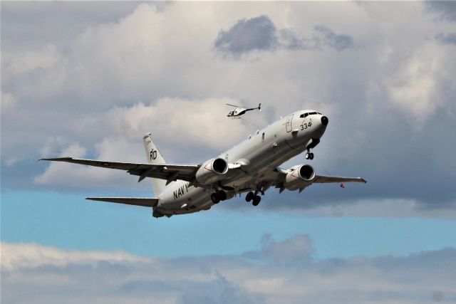 Boeing P-8 Poseidon (16-9334) - KRDD - US Navy P-8A "Poseidon" working the pattern on April 26, 2021 from VP-47 Whidbey Island NAS. I was able to get 5 Touch and Go's before they departed north for Grant County Airport as "Ford II". Lower photos in ground proximity were heat hazed and promptly deleted. The helo above the P-8A was local and was returning from the Redding Airport helicopter training area east of the Runway.