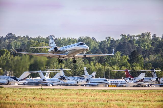 Cessna Citation Sovereign (N516DB) - This is a photo of N516DB, which is a 2005 Cessna 680 seen here departing Augusta Georgia's regional airport shortly after the conclusion of the 2023 Master's tournament. The background only shows a small sampling of all the private jets that were in town for Golfs biggest event. I shot this with a Canon 5Dsr with a Canon 500mm F4 IS lens with a 1.4x extender on it, making the lens' focal length 700mm. The camera setting were 1/8000 shutter, F5.6, ISO, 1600. Please check out my other aviation photography. Votes and positive comments are always appreciated. Questions about this photo can be sent to Info@FlewShots.com