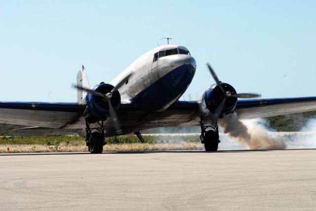 Douglas DC-3 (N86553) - The crew of this old gooney bird is having a horrible time getting the port R-1820 fired up, took almost 10 minutes from first crank to running smoothly