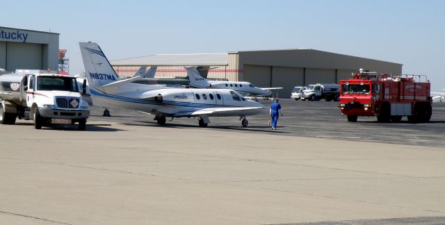 Cessna 500 Citation 1 (N837MA) - Engine 60 of the Blue Grass Airport (KLEX) Public Safety Department stands watch as the ground crew at TAC Air prepares to refuel Lifeguard 837...