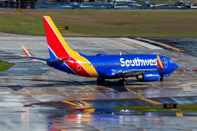 Boeing 737-700 (N220WN) - Holding short runway 4 after a popup storm soaked the airport. Taken 3/4/2020