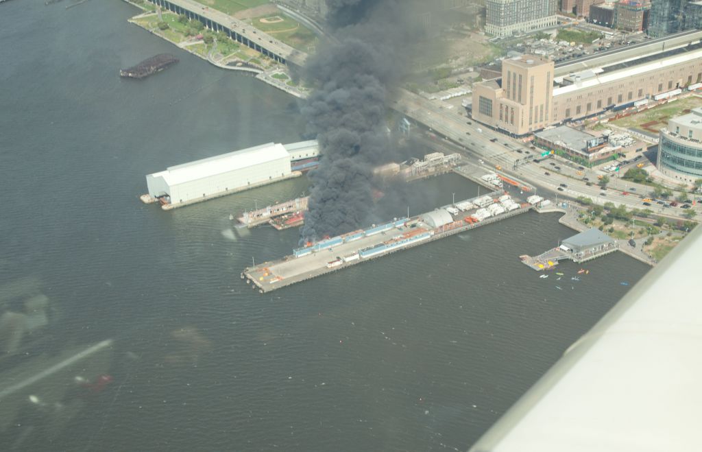 Grumman AA-5 Tiger (N28218) - Fire on one of the docks on the Hudson, near the Entrepid.