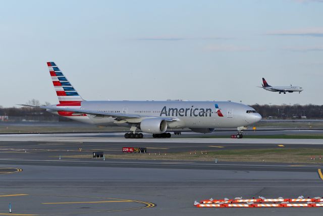 Boeing 777-200 (N750AN) - AAL198 departs to Milan MXP on 22R while DAL2724, N868DN, arrives from PHX on 22L