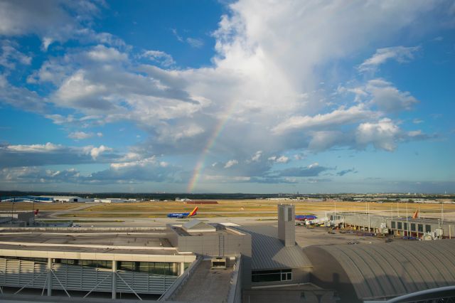 — — - Overview of Airport during a rainbow.