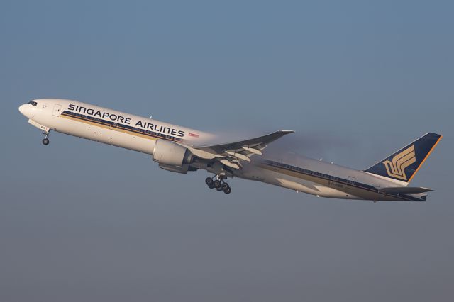 BOEING 777-300ER (9V-SWR) - SIA51 departs for Singapore on a foggy day with condensation over the wings just after take off.