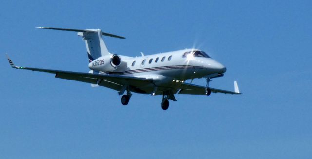 Embraer Phenom 300 (N352QS) - About to touch down is this 2014 Embraer Phenom 300 in the Spring of 2025.