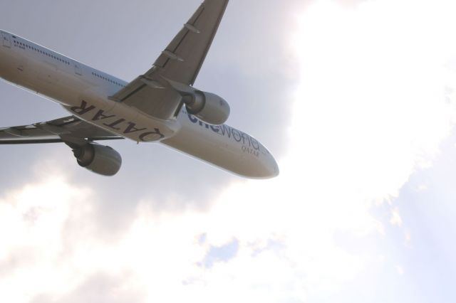 Boeing 777-200 (A7-BAB) - Real lucky shot with the sun popping out just as It took it giving it this result.