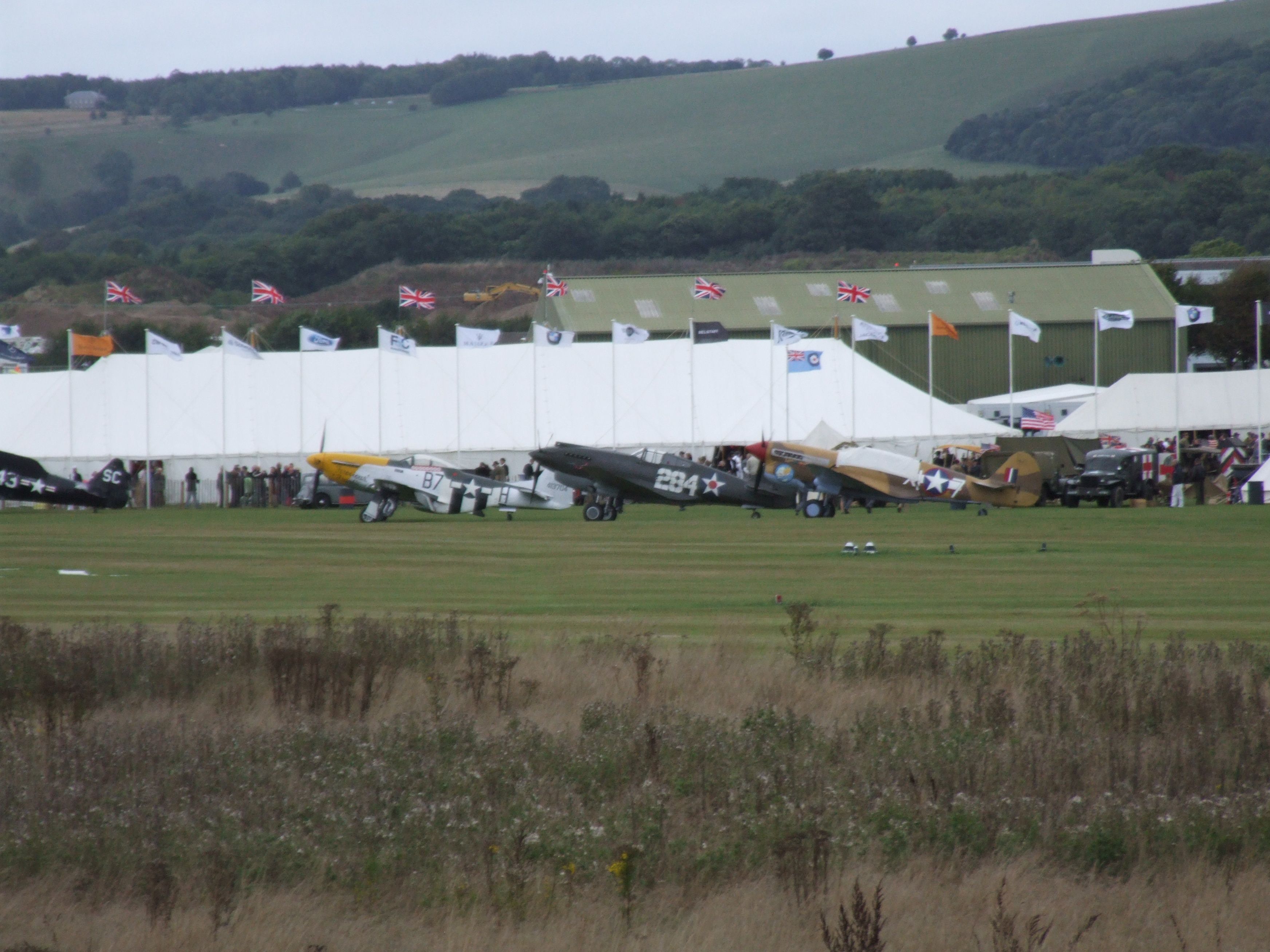 G-CDWH — - Aircraft marked 284 is the P40B referred to in a new squawk “Rare warplane that survived Pearl Harbor attack returns to US”.br /Photo taken at Goodwood Airfield on 15/09/2013. The adjacent P51D & P40F together with a Spitfire MK9 are the subject of an earlier post at the same airfield.