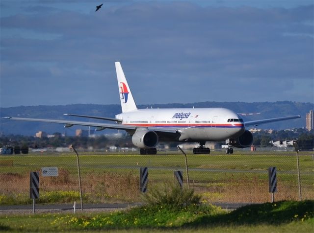 Boeing 777-200 (9M-MRL) - Big bird, little bird.