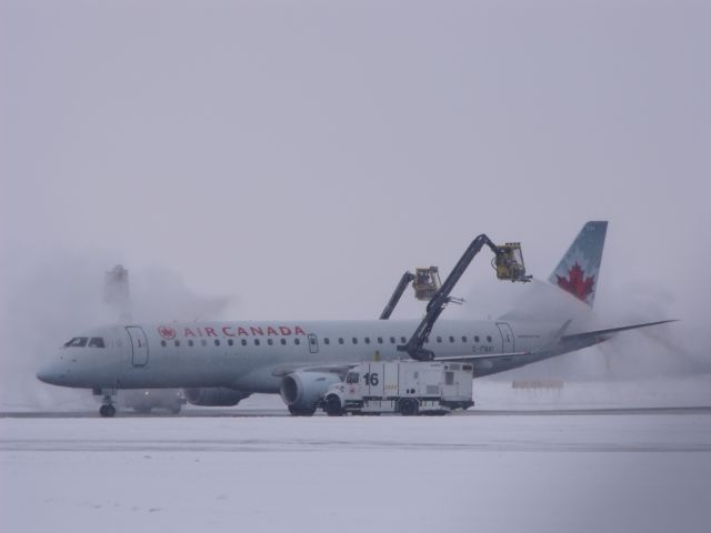 Embraer ERJ-190 (C-FNAI) - being deiced before leaving Ottawa.