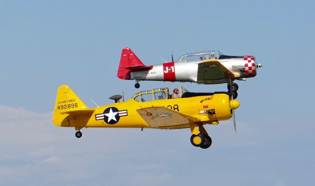 North American T-6 Texan (N36CA) - Two North American T6 Texans (N36CA featured in the back) departing in formation at AirVenture 2015!