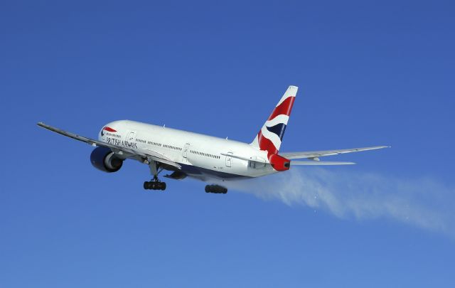 Boeing 777-200 (G-VIIT) - Snow that accumulated in the wheel wells after an overnight storm escapes on departure.