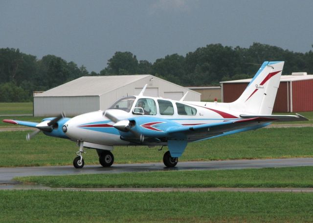 Beechcraft 55 Baron (N1734G) - 1962 Beech 95-A55 taxiing in after landing on runway 23 at Downtown Shreveport. The sky in the background shows this was not a "fun" day to go flying, much less landing! Some serious gust blowing today!