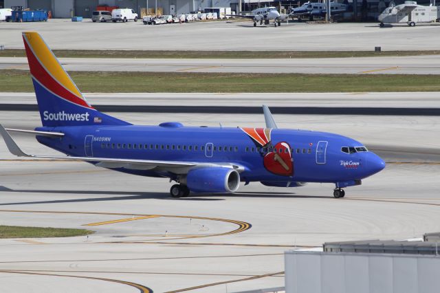 Boeing 737-700 (N409WN) - Southwest Airlines (WN) N409WN B737-7H4 [cn27896] in Triple Crown liverybr /Fort Lauderdale (FLL). Southwest Airlines flight WN1877 taxis to the gate after arrival from Indianapolis International (IND). The aircraft was painted in 2015 with this special ‘Triple Crown’ livery dedicated to Southwest employees’ achievement of the in-house performance Triple Crown Award for five straight years. br /Taken from Terminal 1 car park roof level br /2018 04 07br /a rel=nofollow href=http://alphayankee.smugmug.com/Airlines-and-Airliners-Portfolio/Airlines/AmericasAirlines/Southwest-Airlines-WNhttps://alphayankee.smugmug.com/Airlines-and-Airliners-Portfolio/Airlines/AmericasAirlines/Southwest-Airlines-WN/a