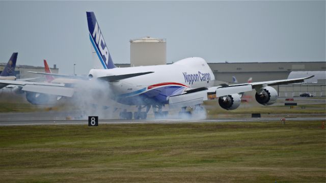 BOEING 747-8 (JA15KZ) - BOE525 makes tire smoke on touchdown on runway 16R on 6/23/13. (LN:1479 cn 36139). The aircraft is using temporary registration #N942BA.