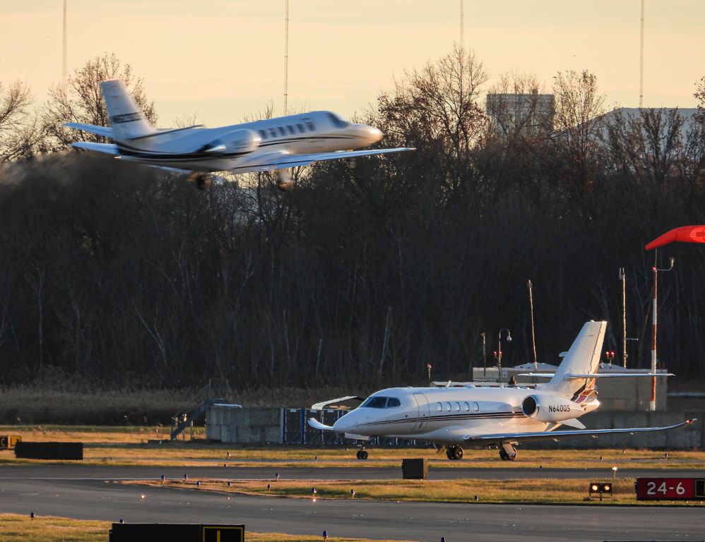 Cessna Citation Latitude (N640QS) - N640QS taxiing down Quebec to runway 24 as N823CB blasts off from runway 24