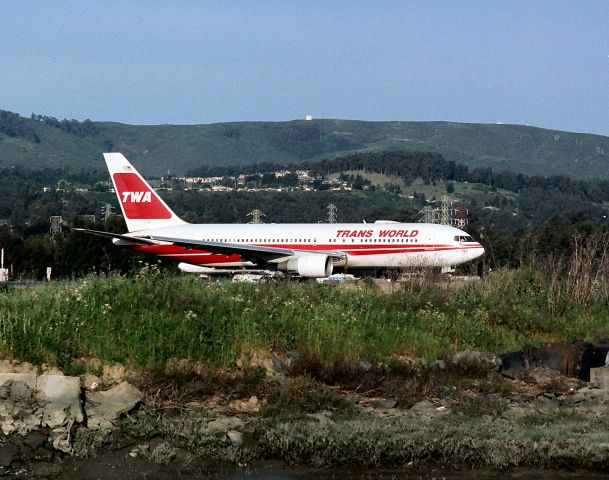 BOEING 767-200 (N602TW) - KSFO- then new TWA 767-200 set to depart 1R at SFO for JFK. Note the tower on top the hill above the 767 - this is Sweeney Ridge and now a park. This used to be a Nike Missle battery in thw 1950s. The tower is the location, just below the ridge, and to the left, where an Austrailian  Constellation impacted the ridge departing SFO many years ago- killing all aboard- due to heavy fog on departure.