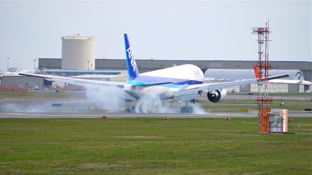 Boeing 777-200 (JA741A) - BOE591 (LN:1005) makes tire smoke during touchdown on runway 16R on 4/9/12.