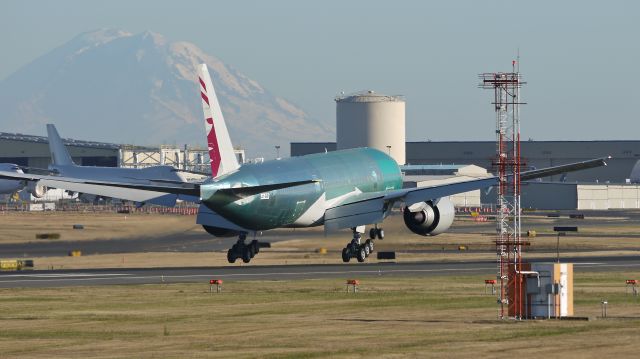 Boeing 777-200 (A7-BBI) - BOE89 - B777-2DZ/LR - about to touchdown on runway 16R on a beautiful evening with Mt Rainier looming in the distance. Photographed 9/6/11.