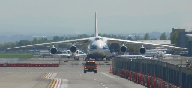 Antonov An-124 Ruslan (RA-82044) - A Pilatus PC-12-45 (N584JV) lends scale to RA 82044 on the ground at PDX.  2d May 2018