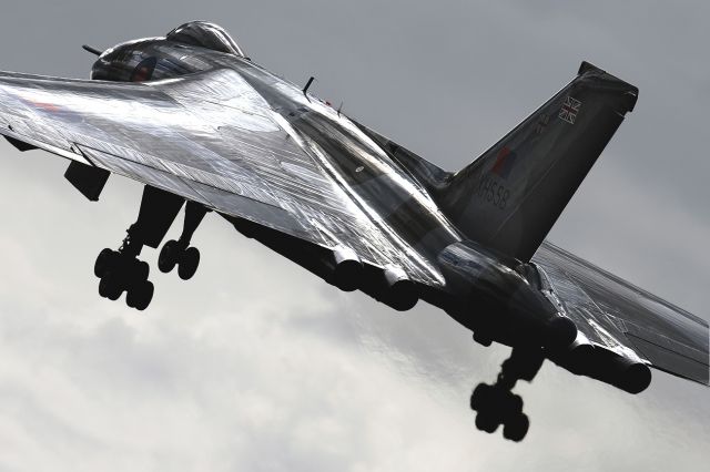 Northrop Spirit (G-VLCN) - Captured close to the runway and feeling the exhaust heat as 'Delta Lady' climbs into a grey sky at the Farnborough FAB International Airshow 13.7.2012.