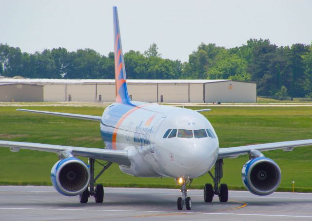 Airbus A320 (N232NV) - Allegiant 8063 arrives at DSM from Charlotte on a military charter is taking off of runway 13/31 as the Delta Taxiway is undergoing resurfacing. This A320 and another Allegiant A320 were coming in with an Iowa National Guard charter after the guard's two weeks training in North Carolina. The BabyBus is turning onto Delta 4 and taxiing into ANG West ramp. 