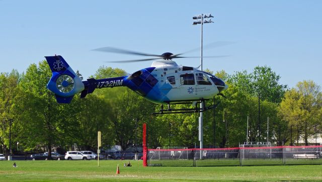 Eurocopter EC-635 (N732HM) - RAHWAY, NEW JERSEY, USA-MAY 09, 2022: A medical transportation helicopter is seen taking off from in front of the Rahway Middle School for a short flight from Robert Wood Johnson Hospital-Rahway, N.J. to Robert Wood Johnson Hospital-New Brunswick, N.J. When transporting to or from RWJ-Rahway, the helicopter will use the school's ball field as a landing zone because the hospital lacks a permanent fixed heli-pad. As such, it uses the nearest fixed heli-pad as its landing code, Merck and Company's 7NJ8, located about a mile away.