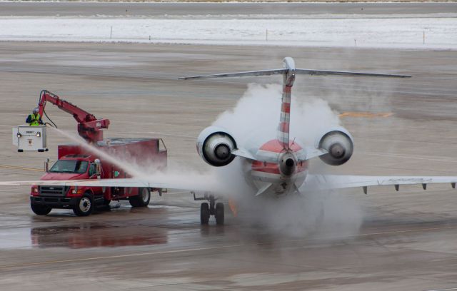 Canadair Regional Jet CRJ-900 (N589NN) - One cold afternoon in December this beauty pulled right out in front of us and made for perfect de-icing pictures! This shot was taken on a Canon EOS 50D at 180mm.