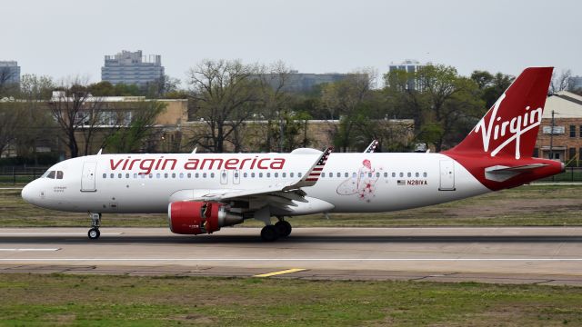 Airbus A320 (N281VA) - Made the inaugural Virgin America flight from San Francisco to Hawaii in November 2015, with a stylized pinup on the port side.br /Flying for Alaska Airlines when this photo was taken.br /Taken March 23, 2018.