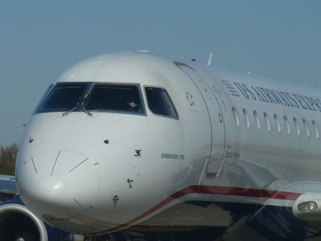 Embraer 170/175 (N125HQ) - Aluminum Overcast 11/8/2013 KCLT - Taxing to RWY 36R being gawked at.  How often do you share taxiway with a B17.