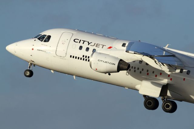 — — - Cityjet BAe 146, departs London City Airport.