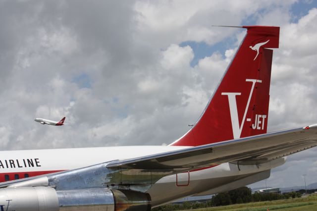 Boeing 707-100 (N707JT) - John Travoltas Boeing 707 in the Qantas V Jet livery at Brisbane airport celebrating the 90th Birthday of Qantas with a Qantas 737-800 in the background.