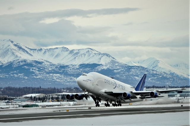 Boeing Dreamlifter (N780BA) - Standing on the west side of Ted Stevens International Airport runway. The Dreamlifter was taking off. March 5, 2019