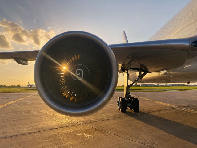 Boeing 757-200 (N794FD) - The setting sun shines through FedEx "Ruby Rose's" No. 2 engine on a summer solstice day moments before "push back". 